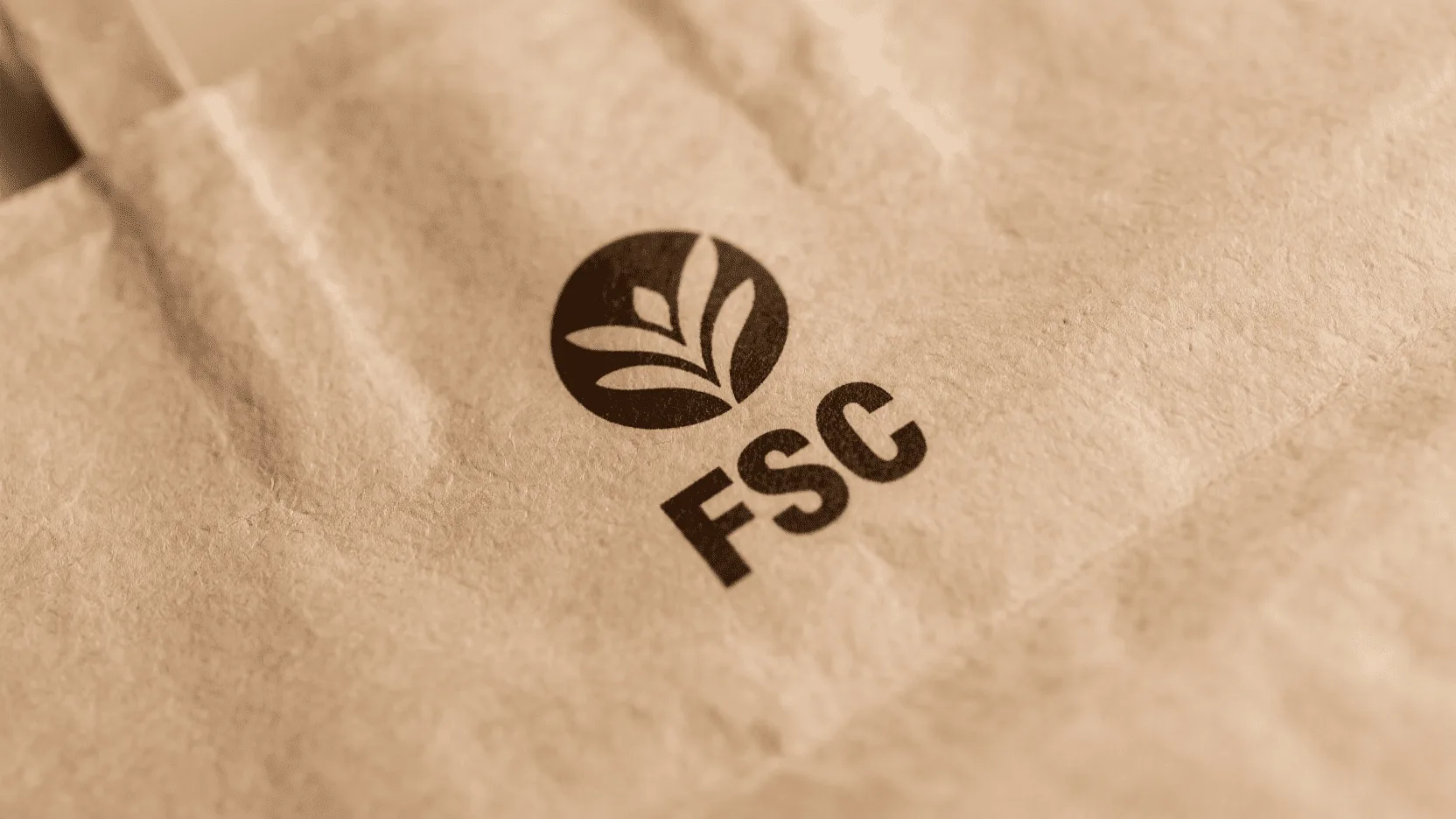 A close-up of the FSC logo printed on a textured paper bag.