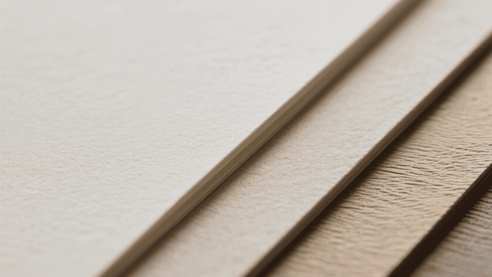 A close-up shot showing the edge and texture of three different paper stocks, one thin, one medium, and one thick.