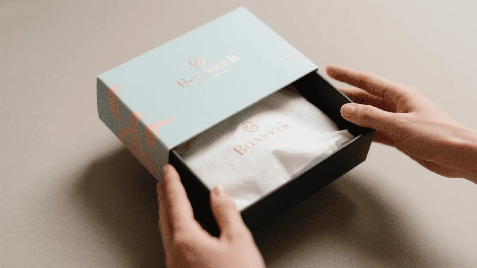 Hands opening a beautifully designed custom box with branded tissue paper inside.