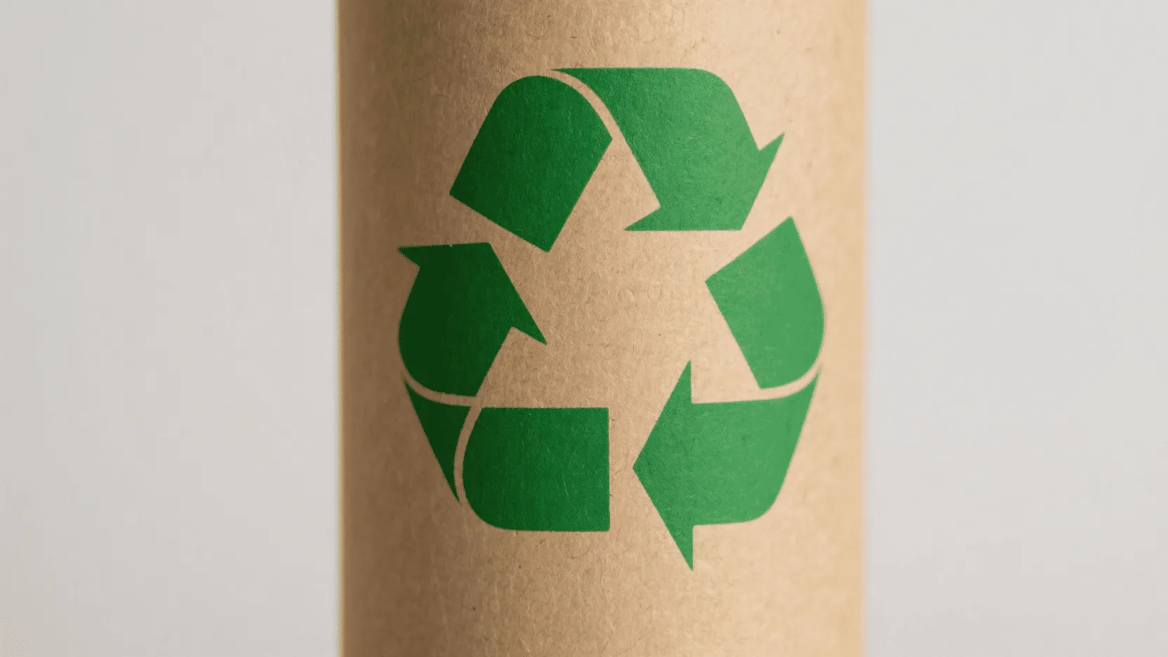 A roll of plain brown kraft paper with a green recyclable symbol clearly visible.