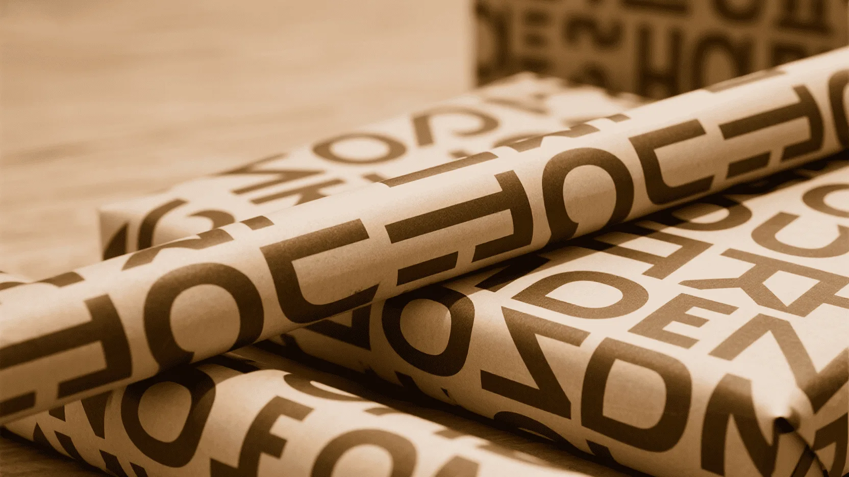 Wrapping paper featuring a bold, repeating typographic pattern in a modern font.