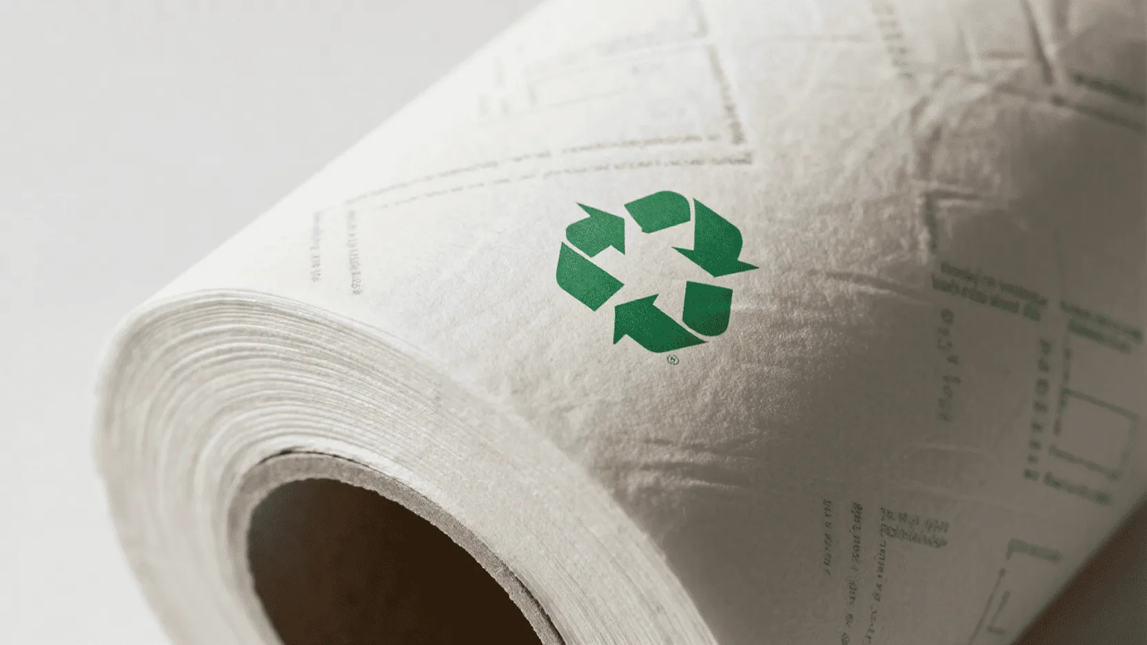 A roll of clean white kraft paper with a green recycling symbol subtly watermarked on it.